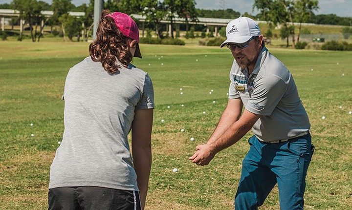 golf instructor demonstrating a golf swing