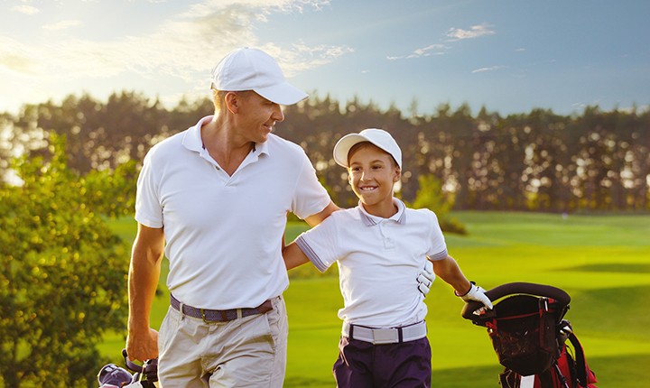 Father and son playing golf